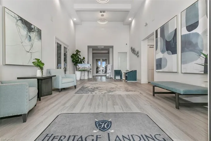 Entrance foyer featuring a high ceiling, wood finished floors, and recessed lighting