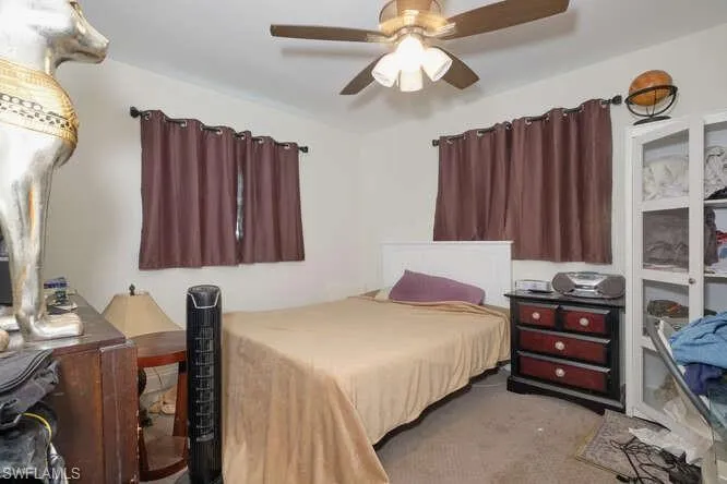 Bedroom featuring ceiling fan and carpet floors