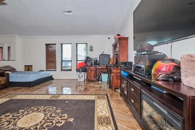 Tiled living room featuring ornamental molding