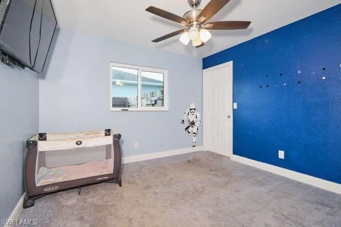Bedroom featuring carpet and ceiling fan