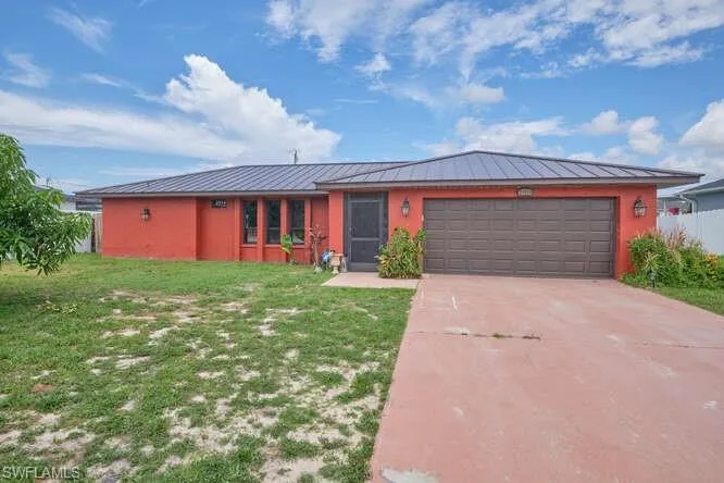 Single story home featuring a front lawn and a garage