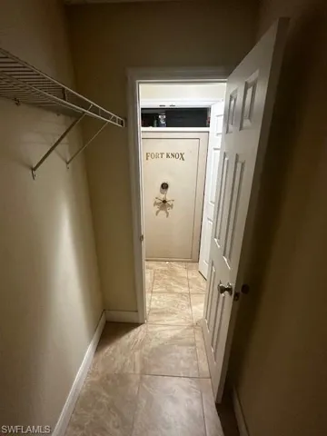 Hallway with light tile patterned flooring
