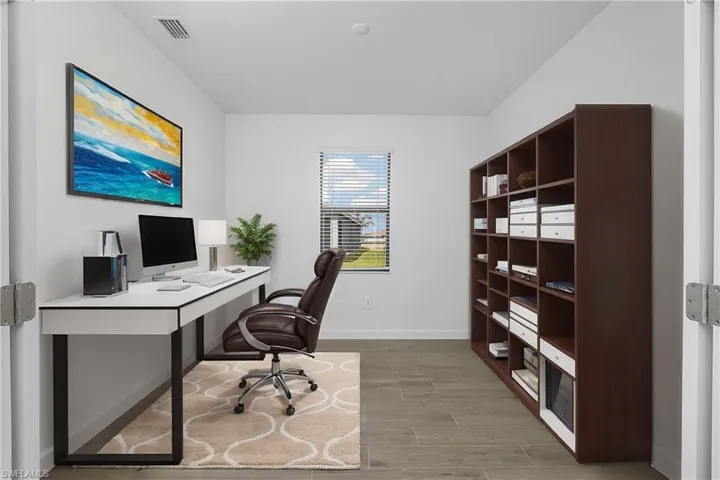 French doors leading into home office/den. (furnishings digitally staged)
