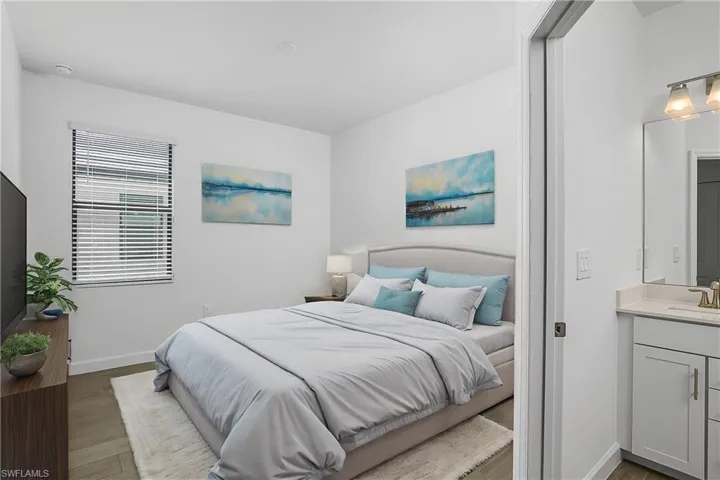 Guest bedroom includes an ensuite bath. (furnishings digitally staged)