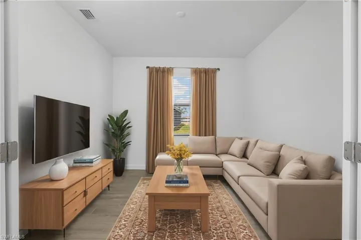 French doors leading into home office/den. (furnishings digitally staged)
