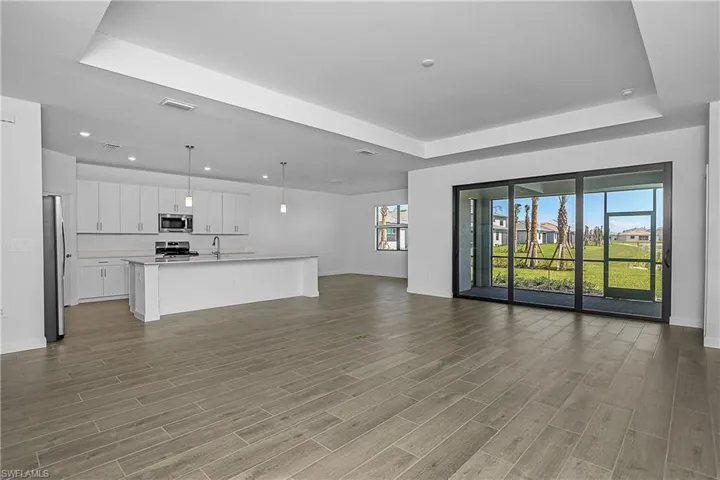 Open Great room, kitchen, dining with impact doors/windows.