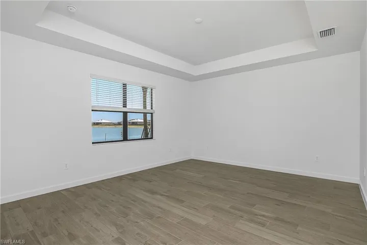 Owner suite is spacious and features beautiful lake views. (furnishings digitally staged)