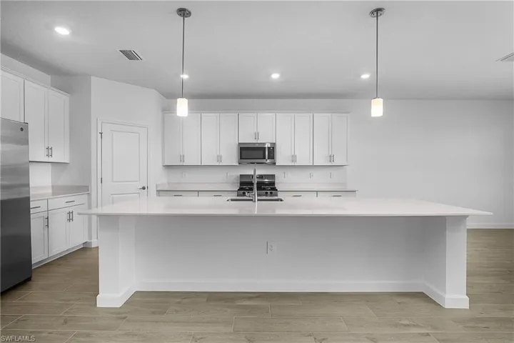 Lots of natural light in this spacious kitchen with plenty of cabinet and storage space.