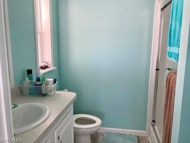 Bathroom featuring a shower stall and vanity