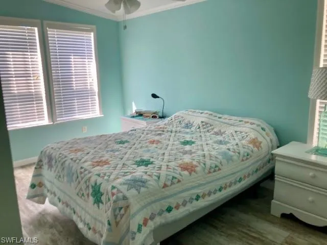 Bedroom with ornamental molding and ceiling fan
