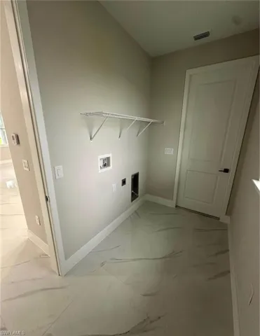 Laundry room featuring light marble finish flooring, hookup for a washing machine, and electric dryer hookup