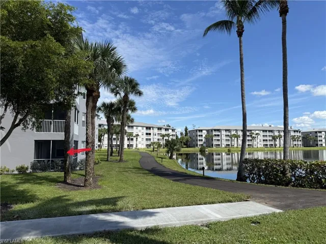 View of home's community with a water view and a yard