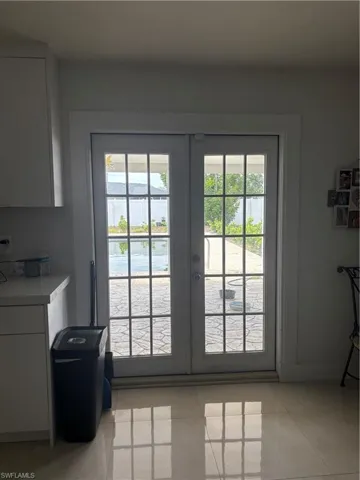 Spare room featuring ceiling fan and light tile patterned floors
