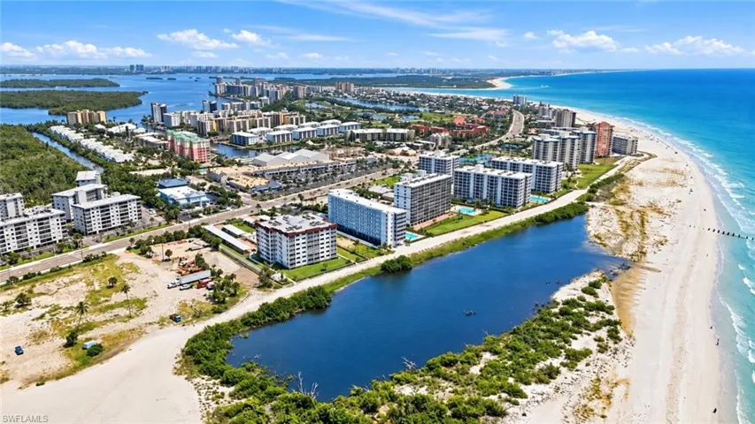 Coastal urban landscape with a prominent shoreline, a body of water, and multiple high-rise buildings - Virtually Edited Image