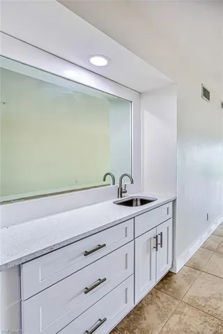 Bathroom featuring recessed lighting, vanity, baseboards, visible vents, and tile patterned floors