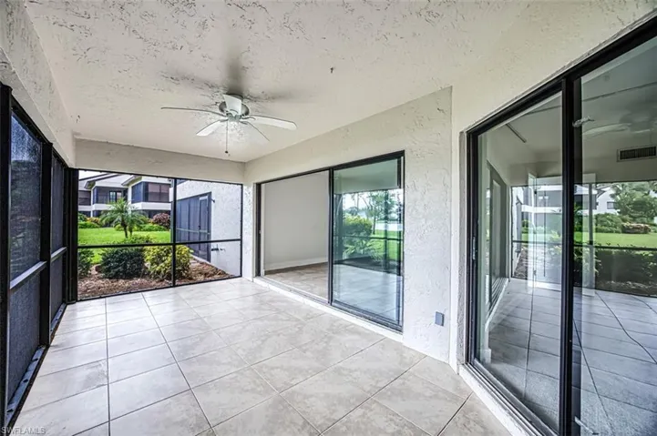Unfurnished sunroom with ceiling fan and visible vents