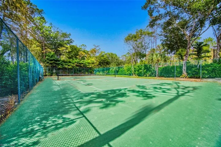 View of sport court featuring fence