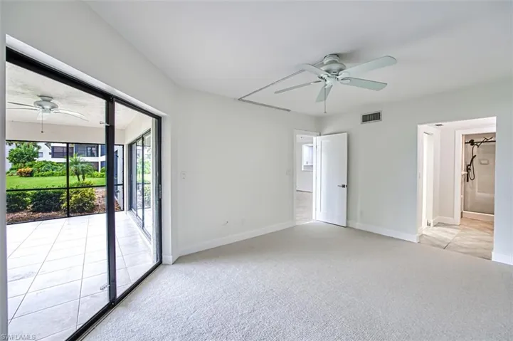 Spare room featuring baseboards, visible vents, ceiling fan, and light colored carpet