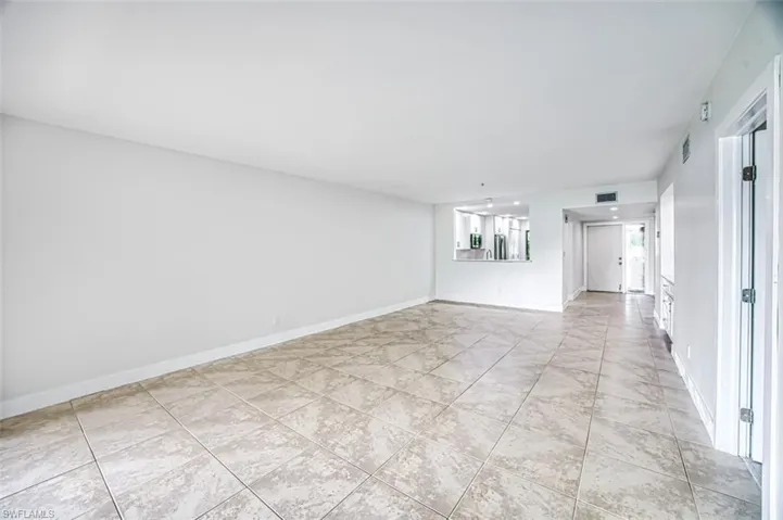 Empty room featuring visible vents and baseboards