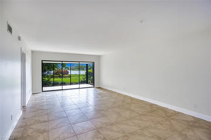 Spare room with visible vents, baseboards, and light tile patterned flooring