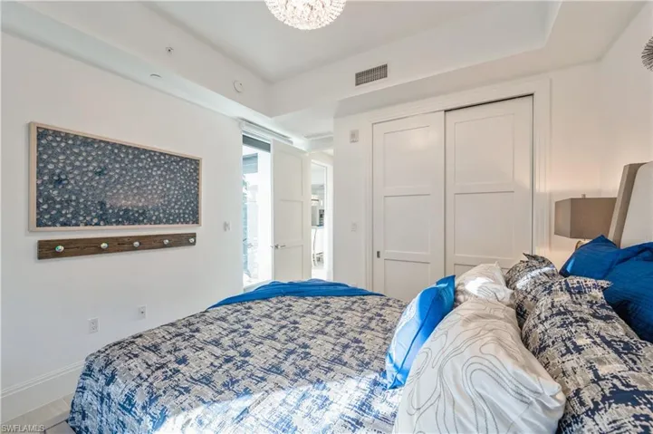 Bedroom with an inviting chandelier and a closet