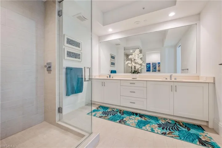 Bathroom featuring vanity and an enclosed shower