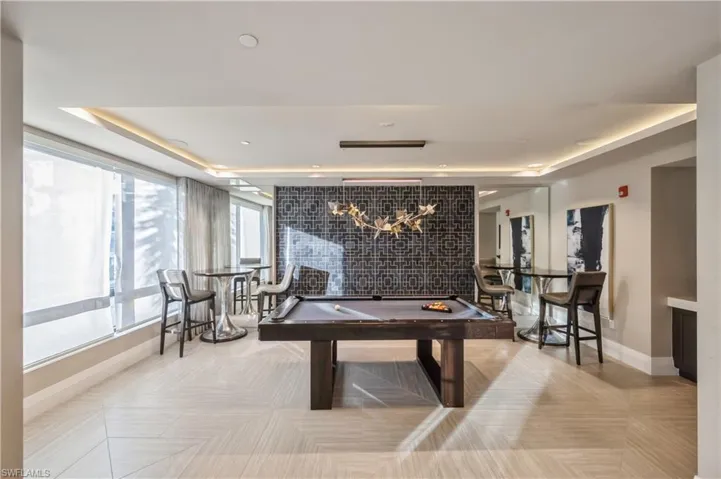 Playroom with pool table and a tray ceiling