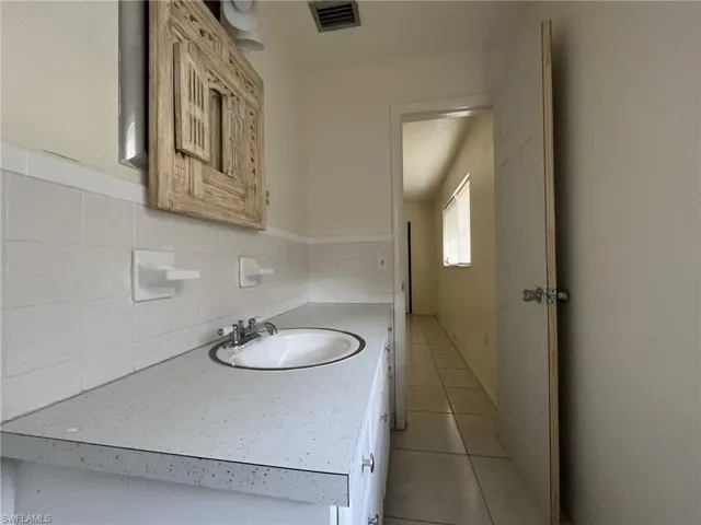 Bathroom with visible vents, vanity, and tile patterned flooring