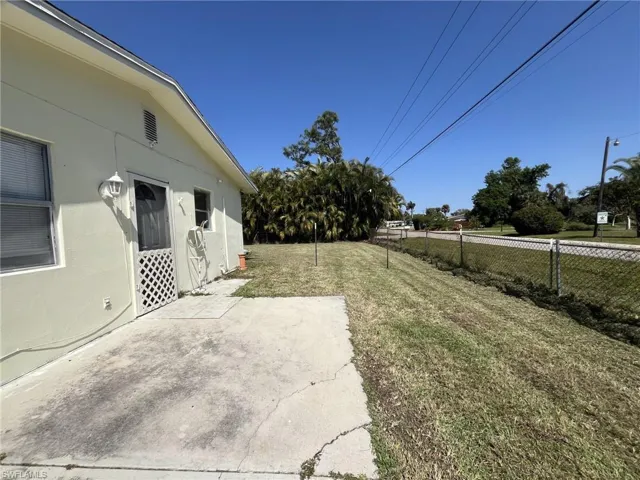 View of yard with fence and a patio area