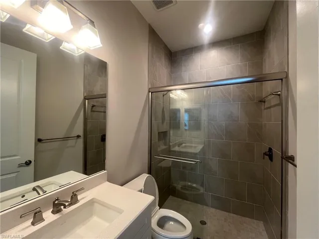 Full bath featuring vanity and a stall shower