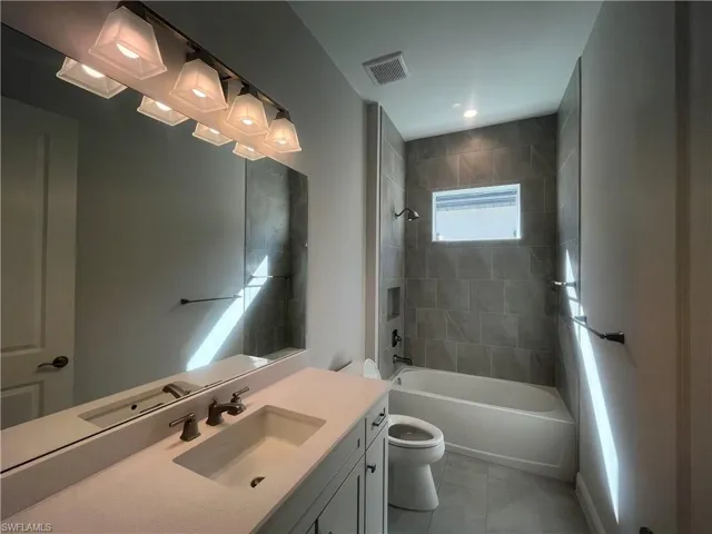 Full bathroom with vanity and bathtub / shower combination