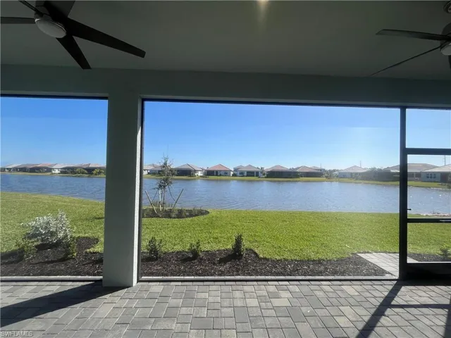 Unfurnished sunroom featuring a residential view and a water view