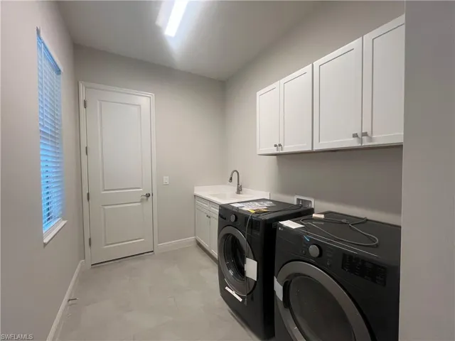Laundry room with cabinet space and independent washer and dryer