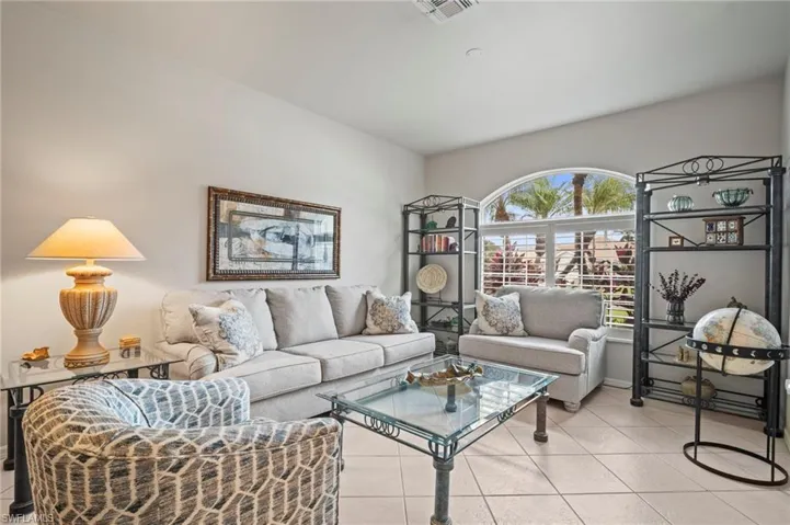 Living area featuring light tile patterned flooring and baseboards