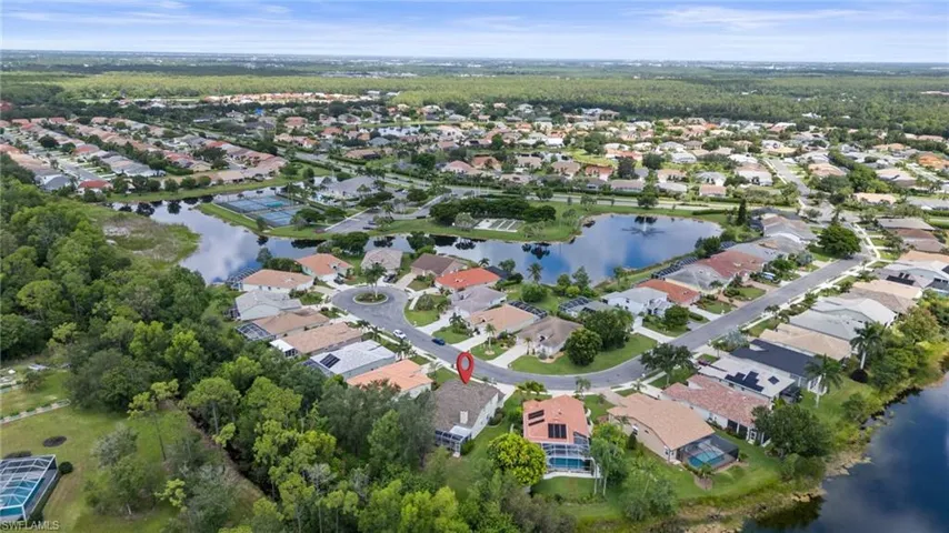Aerial view of property and surrounding area with a large body of water and nearby suburban area