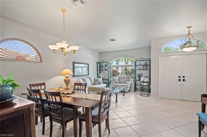 Dining room with a chandelier and light tile patterned floors