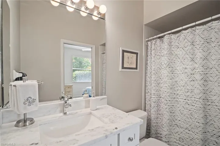 Bathroom featuring vanity and a shower with shower curtain