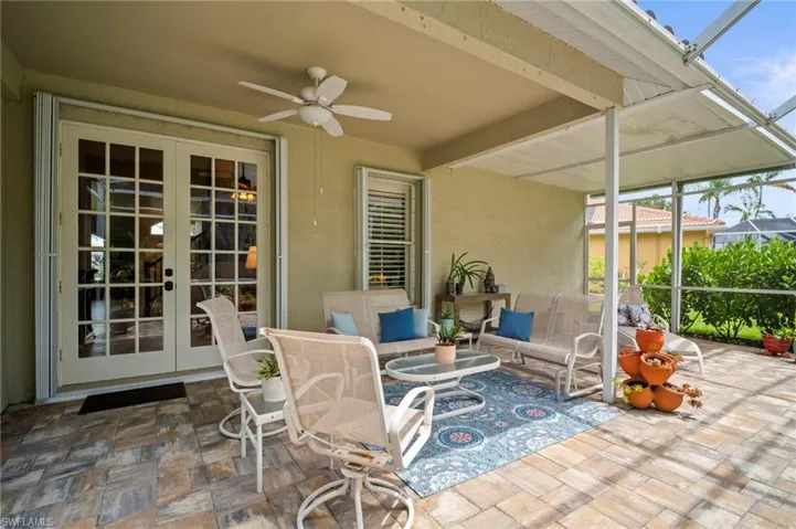 View of patio with a sunroom, a lanai, ceiling fan, outdoor lounge area, and french doors