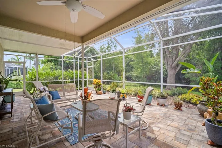 Sunroom with a patio, ceiling fan, and an outdoor living space