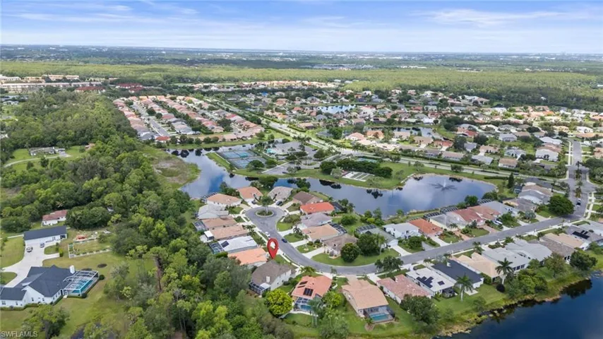 Aerial view of property's location featuring nearby suburban area and a large body of water