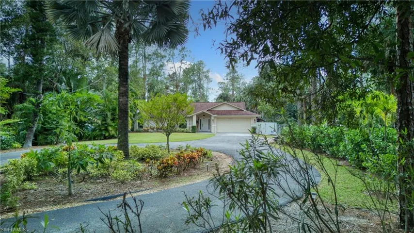 View of front of home featuring a front yard and a garage