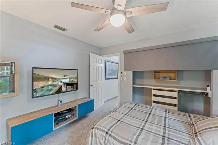 Bedroom with light carpet and ceiling fan