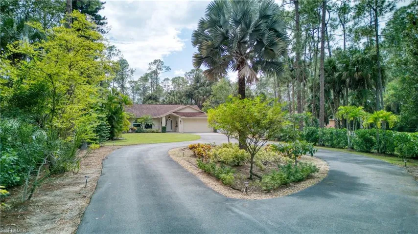 View of front of house with a front lawn and a garage