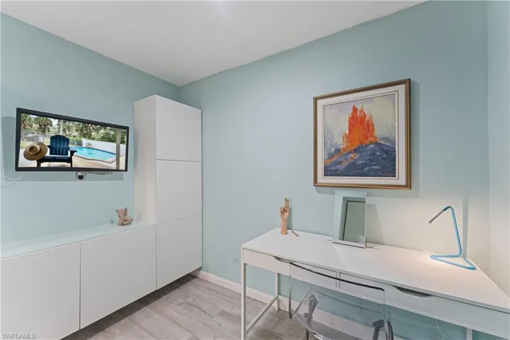 Office space with light hardwood / wood-style flooring
