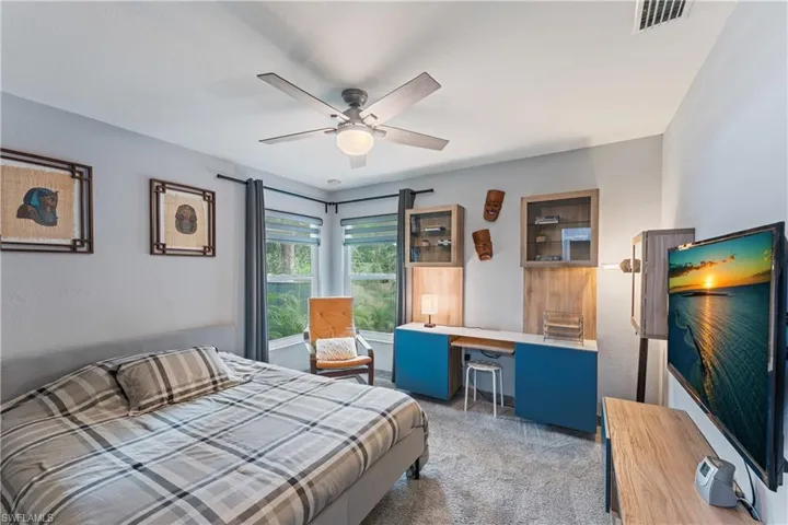 Carpeted bedroom with ceiling fan