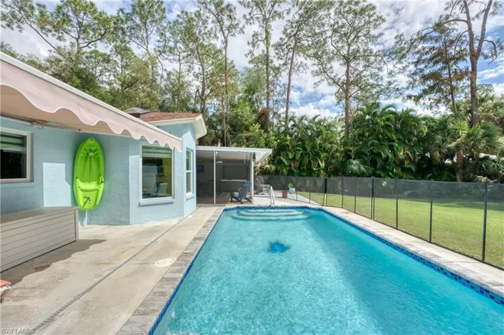 View of pool featuring a patio and a lawn