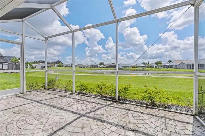 Unfurnished sunroom featuring a residential view and a water view