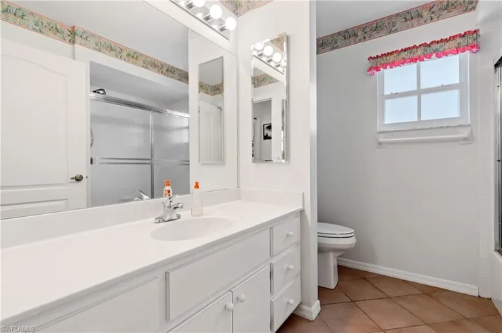 Full bath featuring vanity and tile patterned flooring