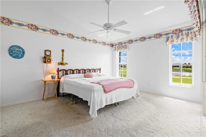 Bedroom with carpet flooring, lofted ceiling, and a ceiling fan
