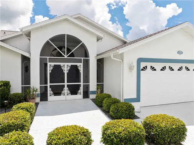 View of front of property featuring stucco siding and a garage